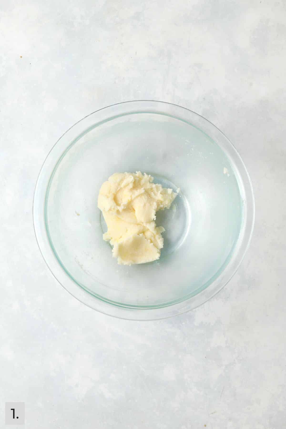 Butter and sugar creamed together in a mixing bowl.